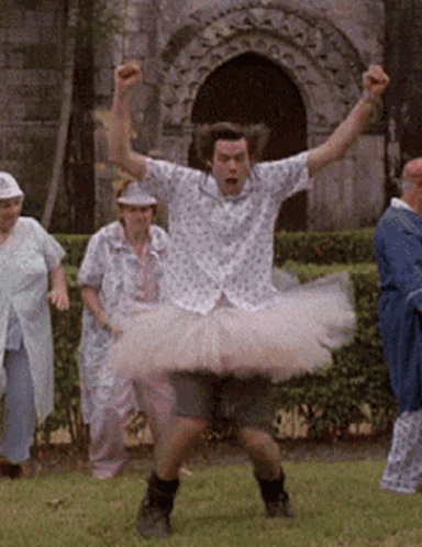 Jim Carrey's Ace Ventura wearing a pink tutu and dancing ballet with comedic flair.