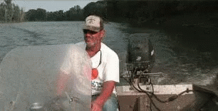 A boater gets smacked in the face by a flying fish.