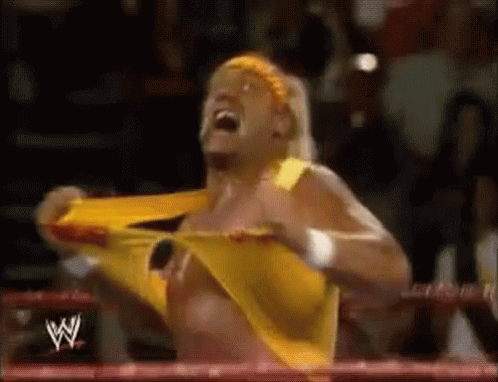 Hulk Hogan shows off his incredible strength by effortlessly tearing his shirt apart.