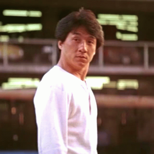 Jackie Chan giving a thumbs up to show approval or satisfaction