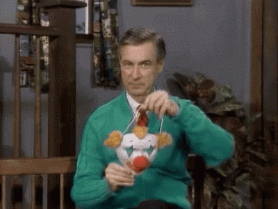Mr. Rogers putting on a clown mask, revealing a creepy side
