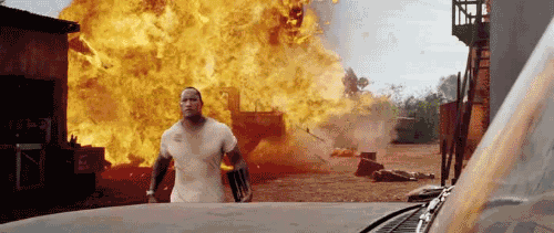 A cool action hero walks away serenely from a fiery explosion, displaying ultimate badassery.