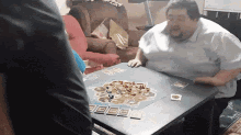 A frustrated player flips the game table of Settlers of Catan in anger.