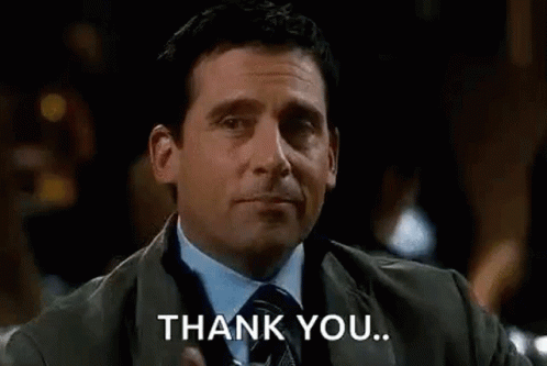 Michael Scott from The Office joyfully acknowledges thanks while making a comical face.