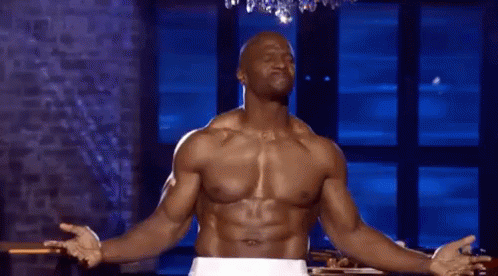 Terry Crews flexing his beastly muscles with a cheeky grin.