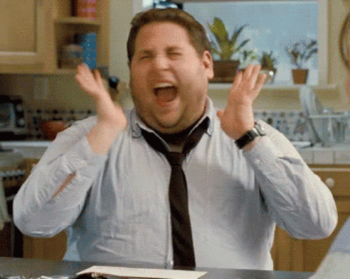 Jonah Hill's character from The Wolf of Wall Street expressing extreme excitement and enthusiasm.